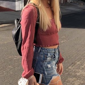 Long sleeve pink crop top.